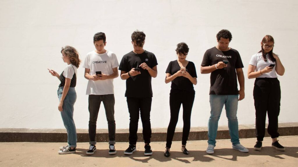 A group of young people using their cellphones