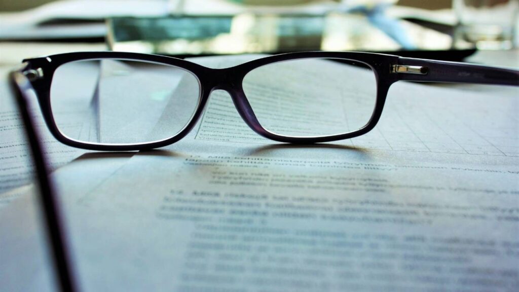 A close-up photo of glasses placed on a piece of paper