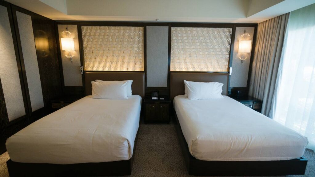 A couple of beds in a hotel room